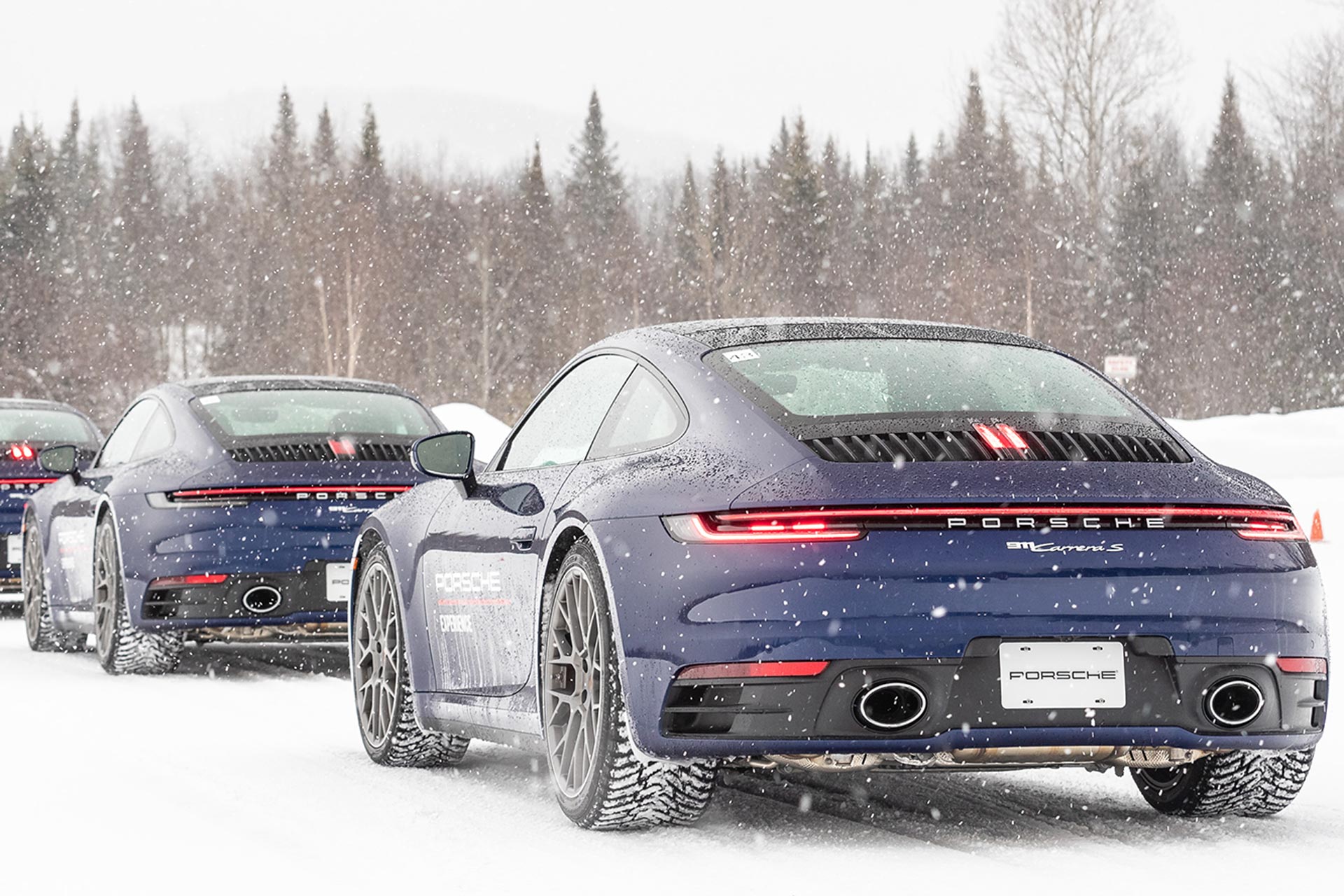 porsche 911 cars parked on snow trail